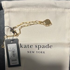 kate spade “T”  gold chain bracelet with logo disc